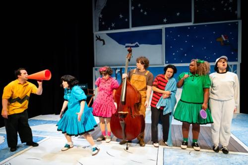 Rolando Cardona directs Karin Terry, Caitlin Sarwono, Jeremy Steckler, Rhys Daly, Chloe Michele, and Tessa "Cricket" James in A Charlie Brown Christmas at Taproot Theatre. Photo by Robert Wade Photography.