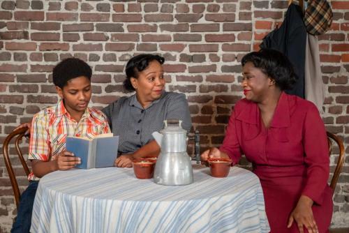 Left to right: Ajani Dickerson, Marlette Buchanan, and Deja Culver in A Raisin in the Sun at Taproot Theatre. Photo by Robert Wade.